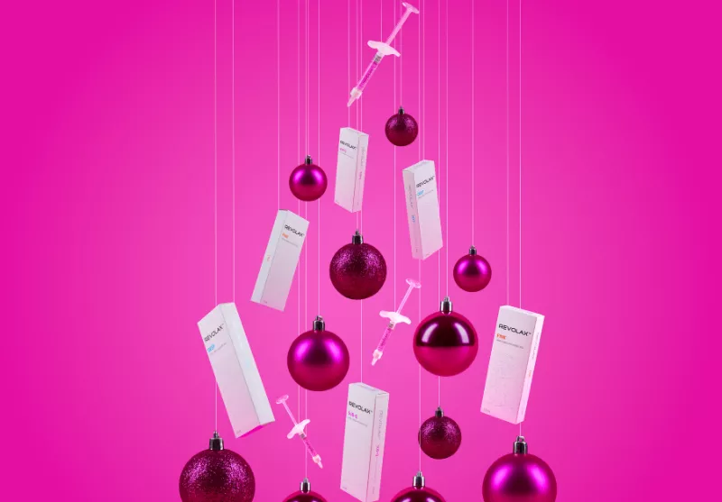 REVOLAX boxes and Christmas baubles on a pink background: Pout prep with REVOLAX