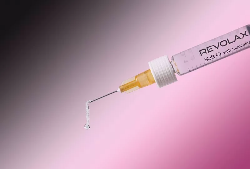 REVOLAX Sub-Q needle on pink and black background