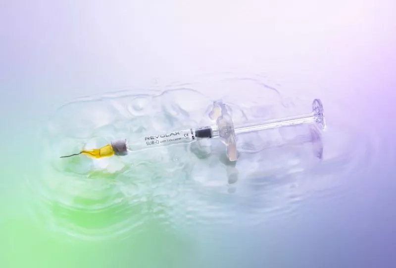 REVOLAX SUB-Q syringe on a purple and green background